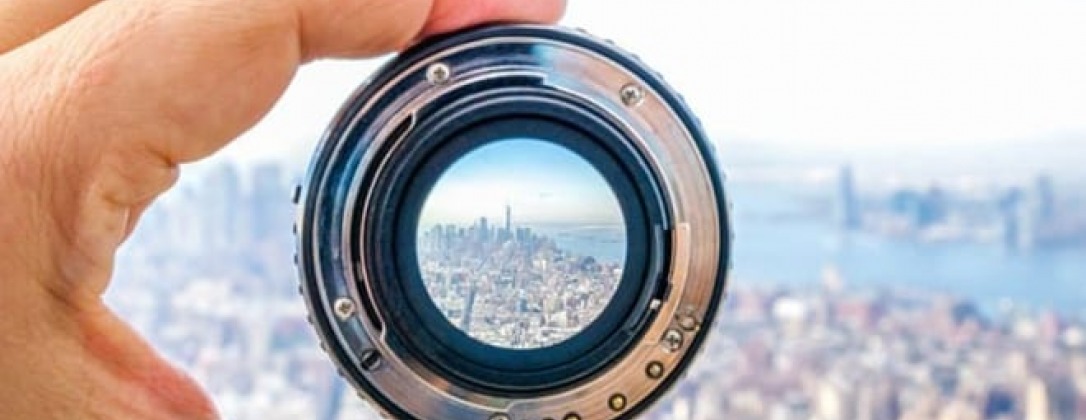a city skyline through a detached camera lens.