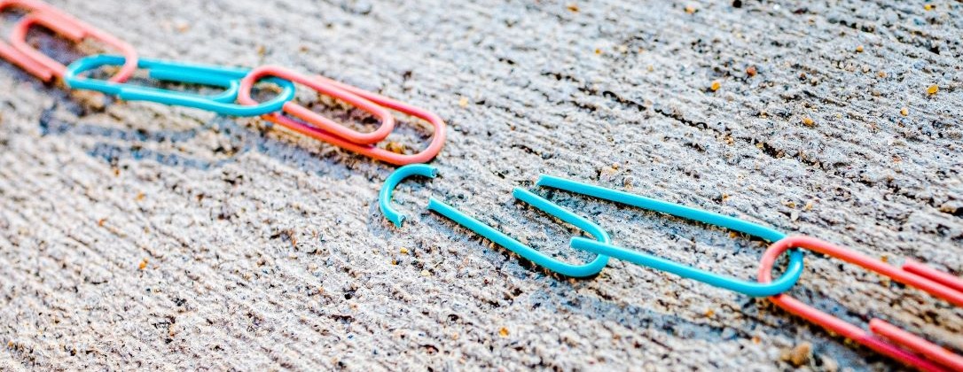 paperclips linked together by a broken paperclip.