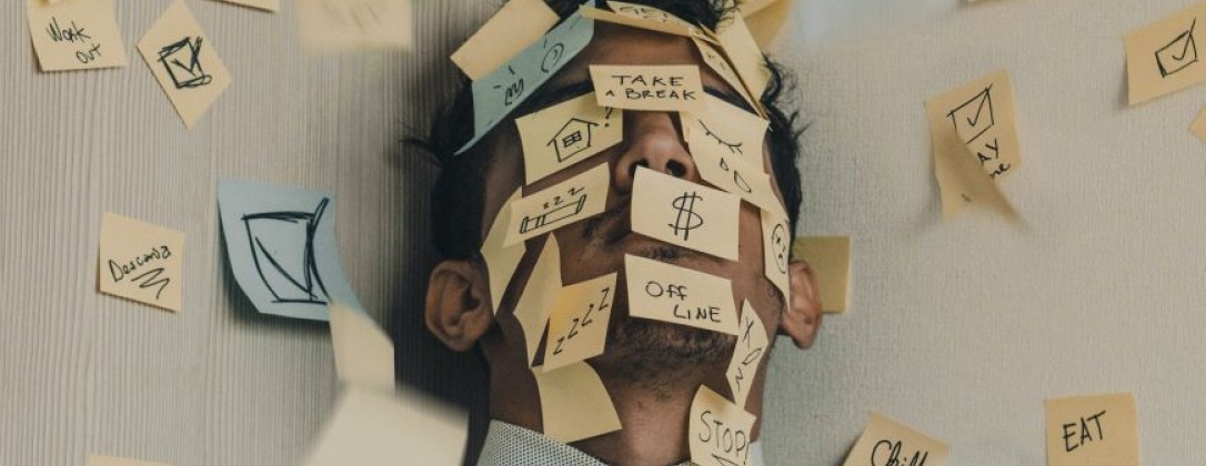 a man covered in sticky notes with advice on them.