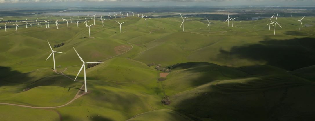 a wind turbine field on a cloudy day.