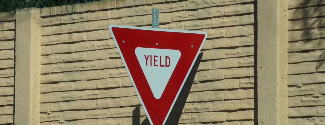 a yield sign in a city street. 