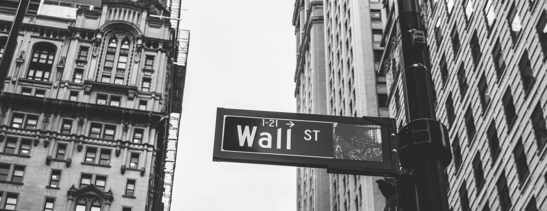A street sign that says wall street in New York City.