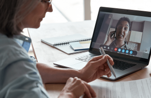 woman working with client over video chat.