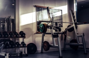 a fitness area with weight lifting equipment.