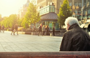 gentleman sitting on a bench.