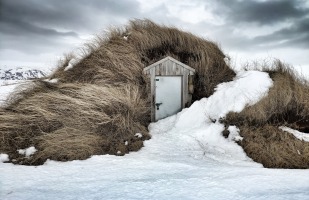 Shelter in a mound of tall grass surrounded by snow